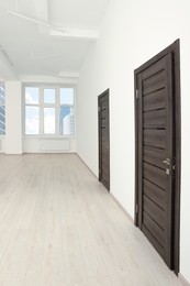 Photo of Modern office room with windows and doors. Interior design