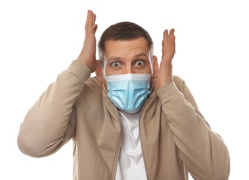 Mature man with protective mask feeling fear on white background