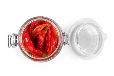 Photo of Open jar of pickled red hot chili peppers on white background, top view
