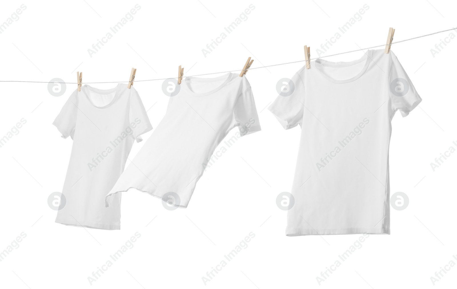 Photo of Many t-shirts drying on washing line isolated on white