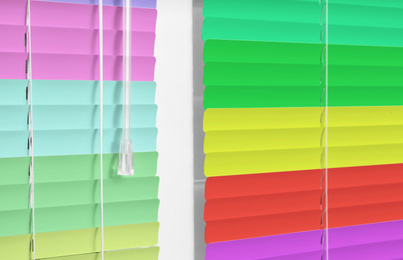 Closed multicolor window blinds as background, closeup view