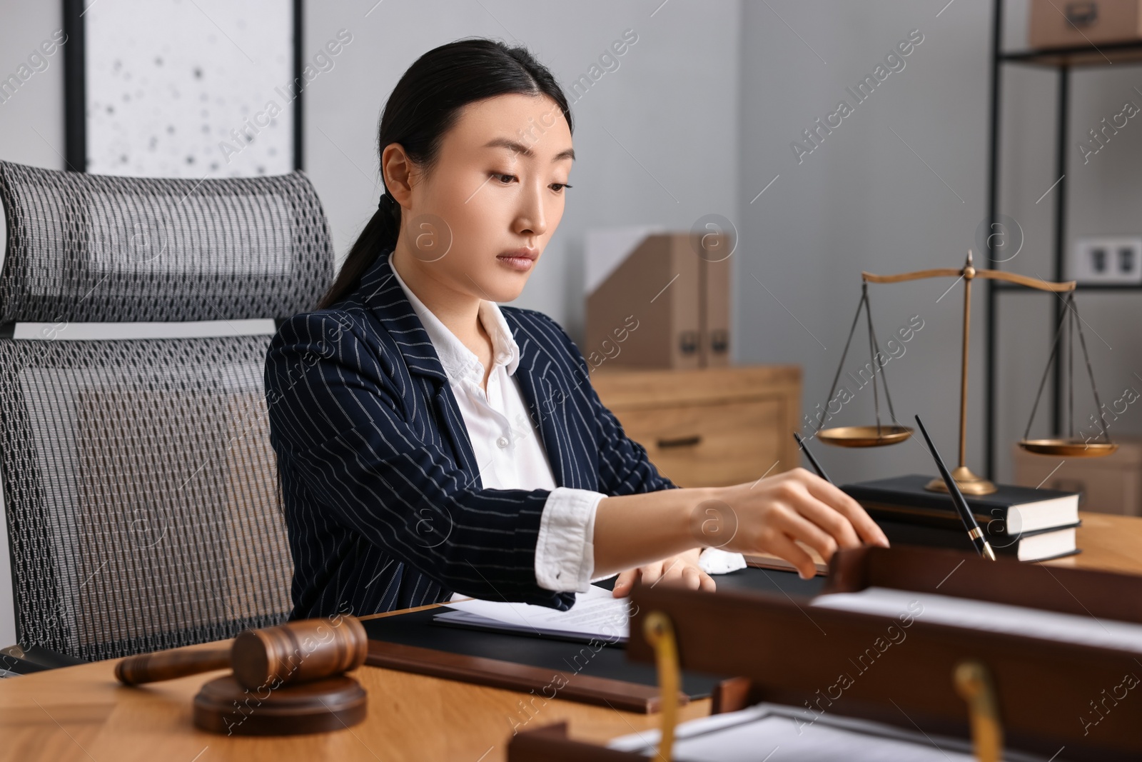 Photo of Notary wearing suit working at table in office