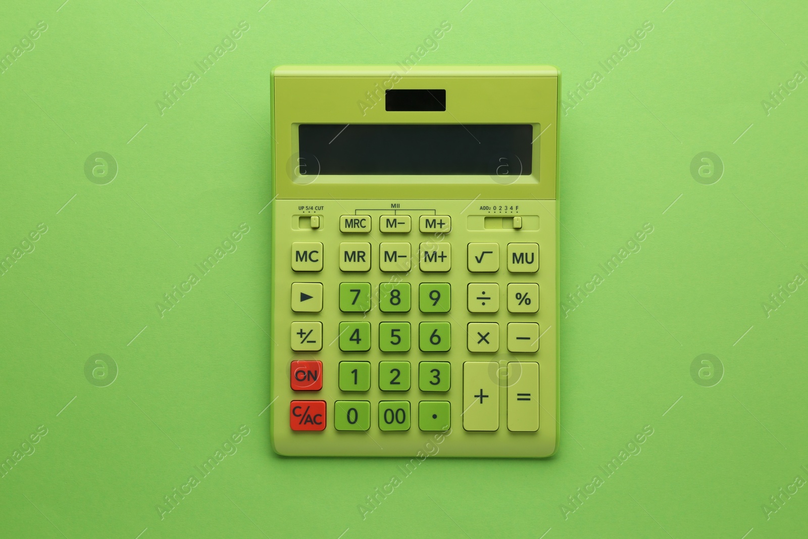 Photo of Modern calculator on green background, top view