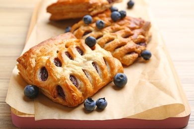 Photo of Fresh delicious puff pastry with fresh berries on table, closeup