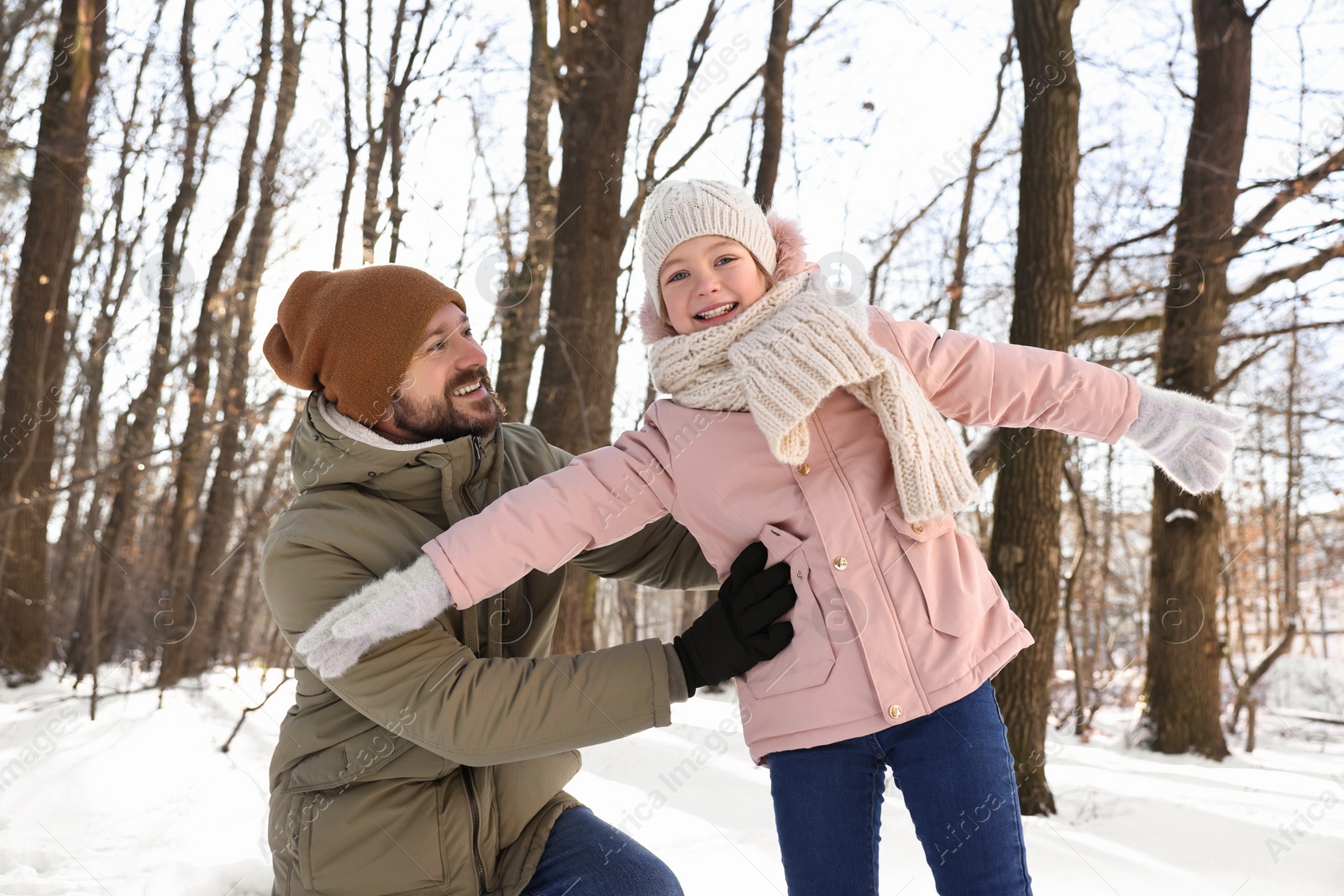 Photo of Family time. Happy father and his daughter in snowy forest