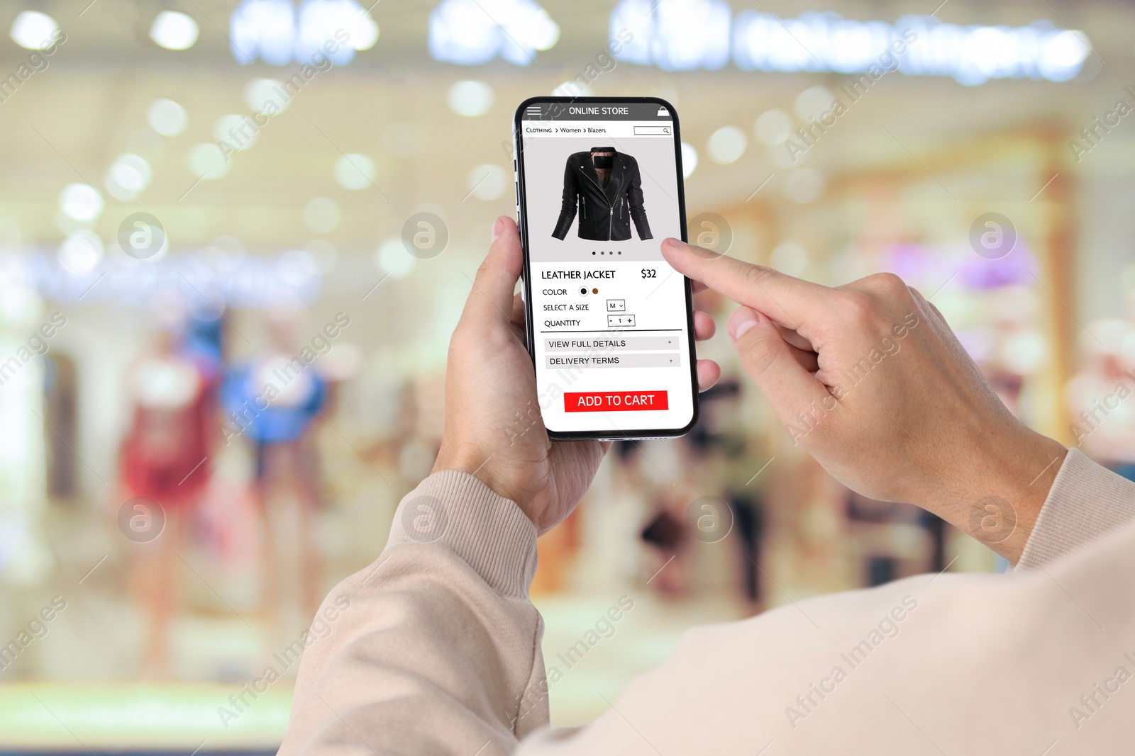 Image of Man visiting shop to take ordered jacket indoors, closeup. Online store website on device screen