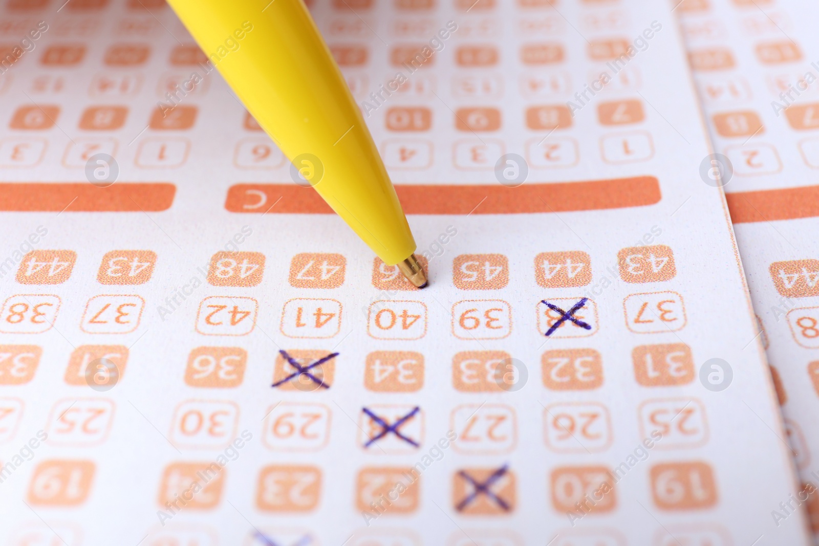 Photo of Filling out lottery ticket with pen, closeup