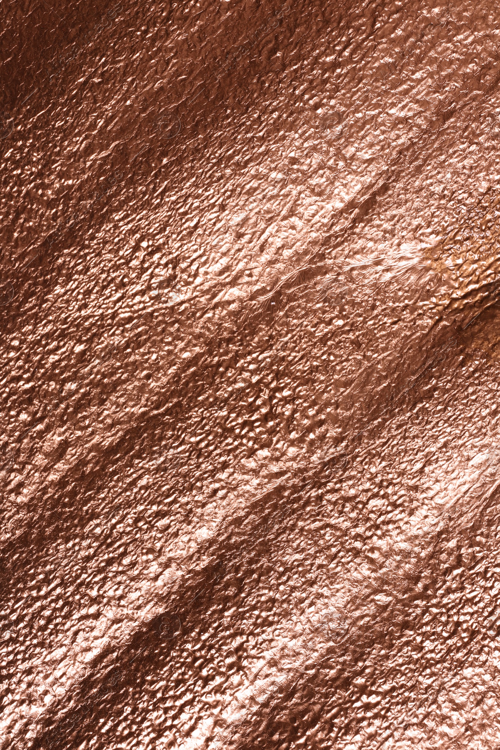 Photo of Rough rose gold surface as background, top view