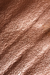 Photo of Rough rose gold surface as background, top view