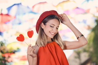 Beautiful woman with candies on city street