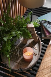 Stylish tray with different interior elements on wooden shelf indoors