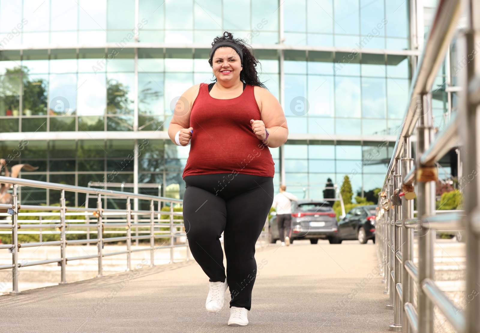 Photo of Beautiful overweight woman running outdoors. Fitness lifestyle