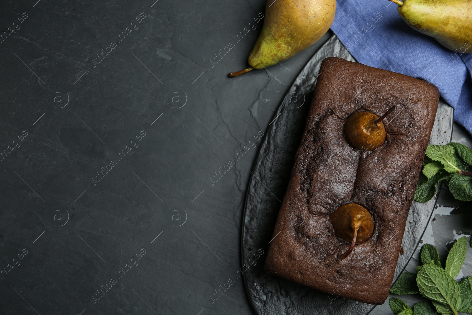 Photo of Flat lay composition with tasty pear bread on black table, space for text. Homemade cake