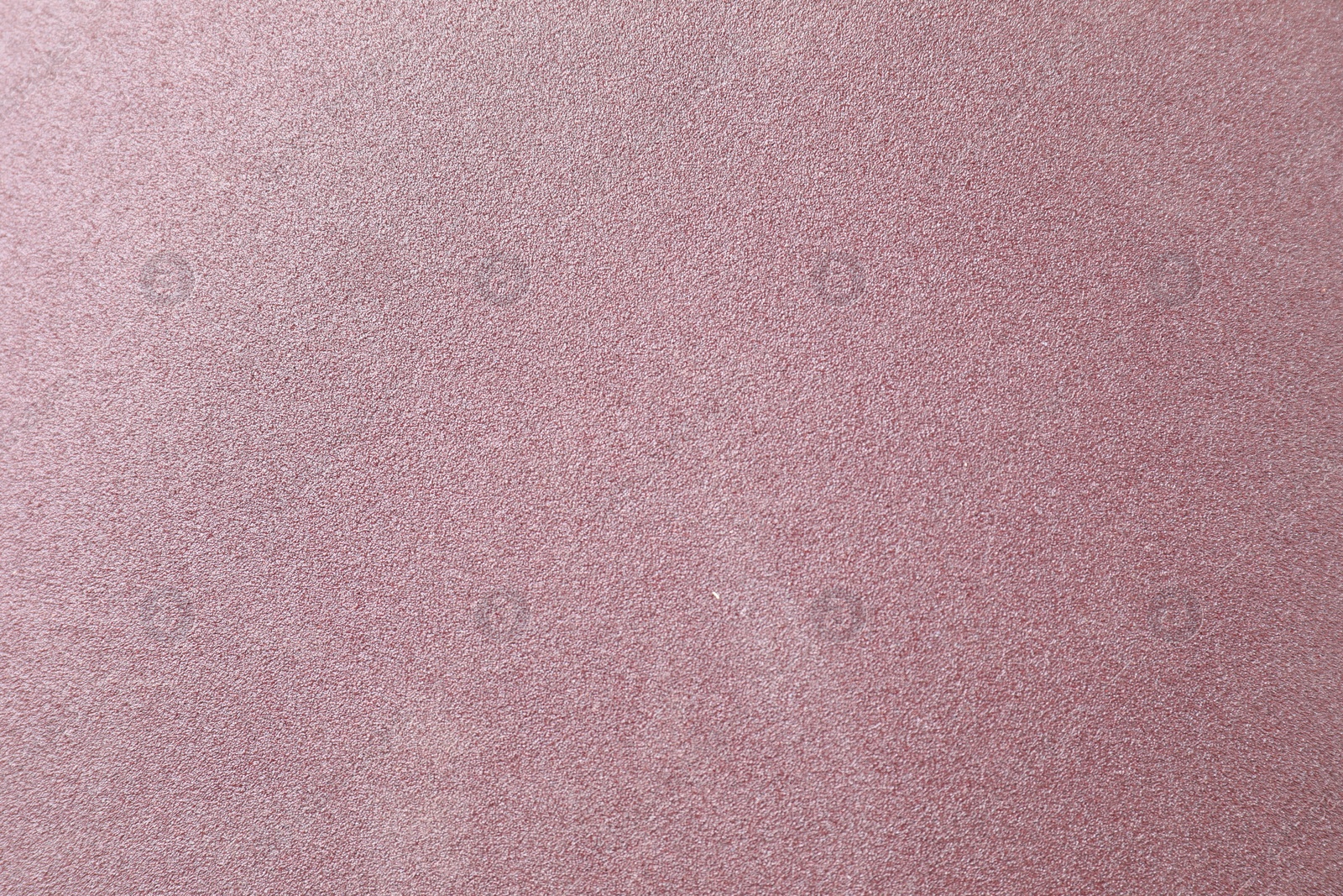 Photo of Texture of coarse sandpaper as background, top view