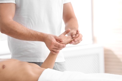 Young man receiving massage in salon, closeup