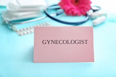 Photo of Card with word GYNECOLOGIST on blue table