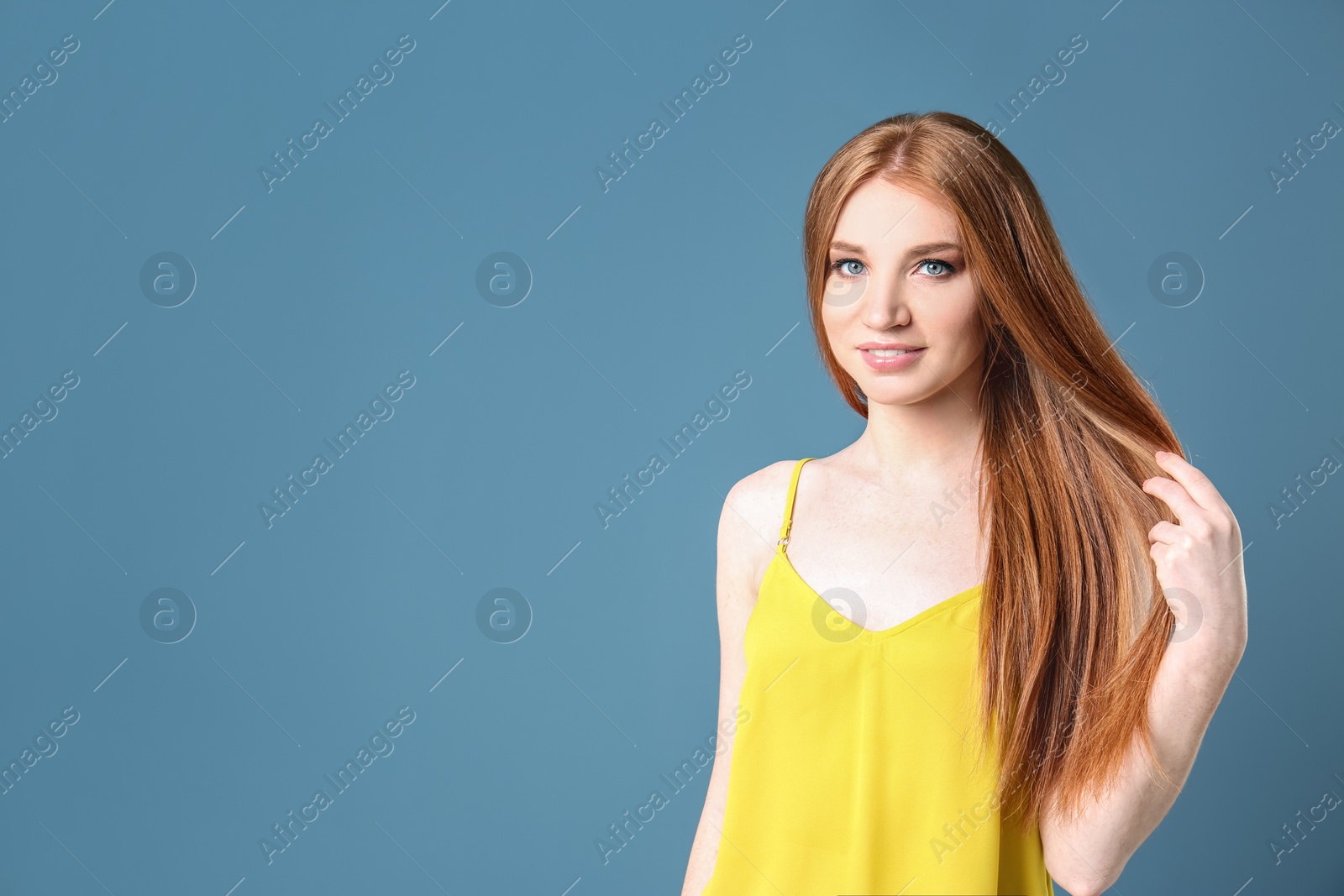 Photo of Portrait of young model with beautiful  hair on color background