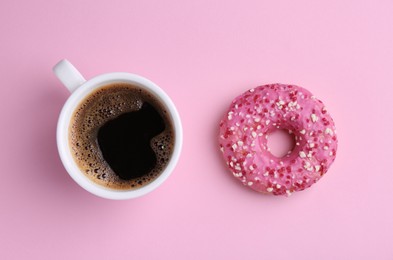 Photo of Tasty donut and cup of coffee on pink background, flat lay