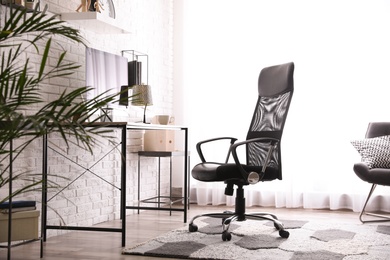 Comfortable chair near desk in modern office interior