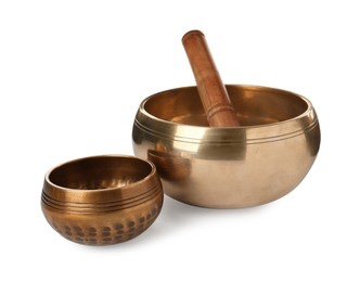 Photo of Tibetan singing bowls and wooden mallet on white background