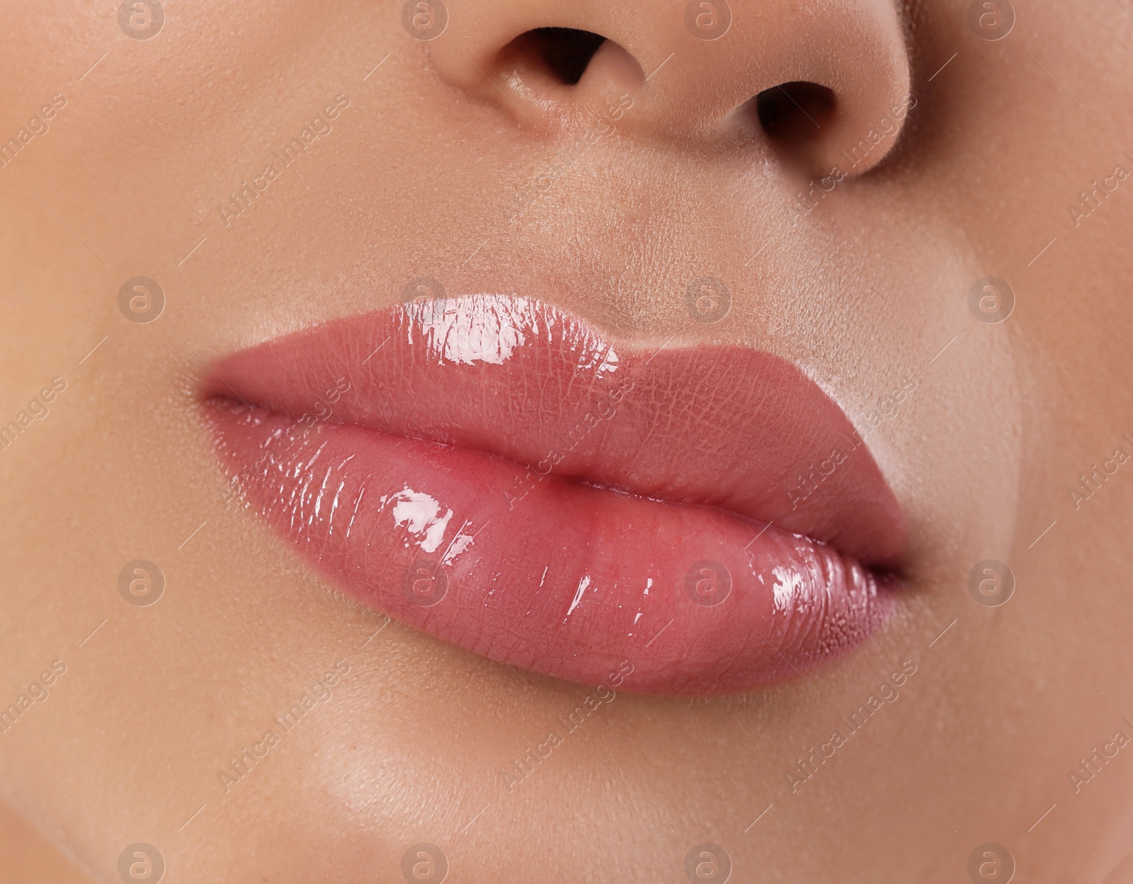 Image of Woman with beautiful perfect lips after permanent makeup procedure, closeup