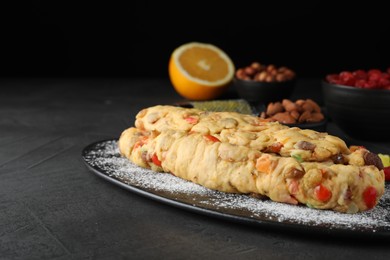 Photo of Unbaked Stollen with candied fruits and raisins on grey table. Space for text