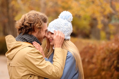 Young romantic couple in park on autumn day