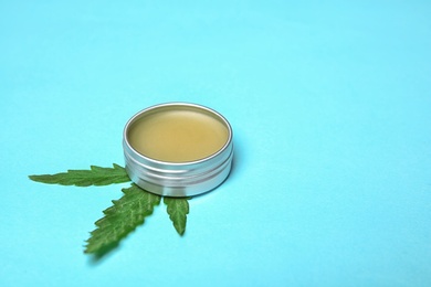 Photo of Jar with hemp lotion and space for text on color background