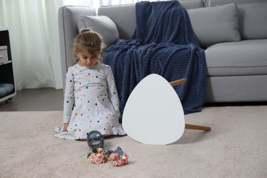 Photo of Child and broken ceramic vase on floor at home