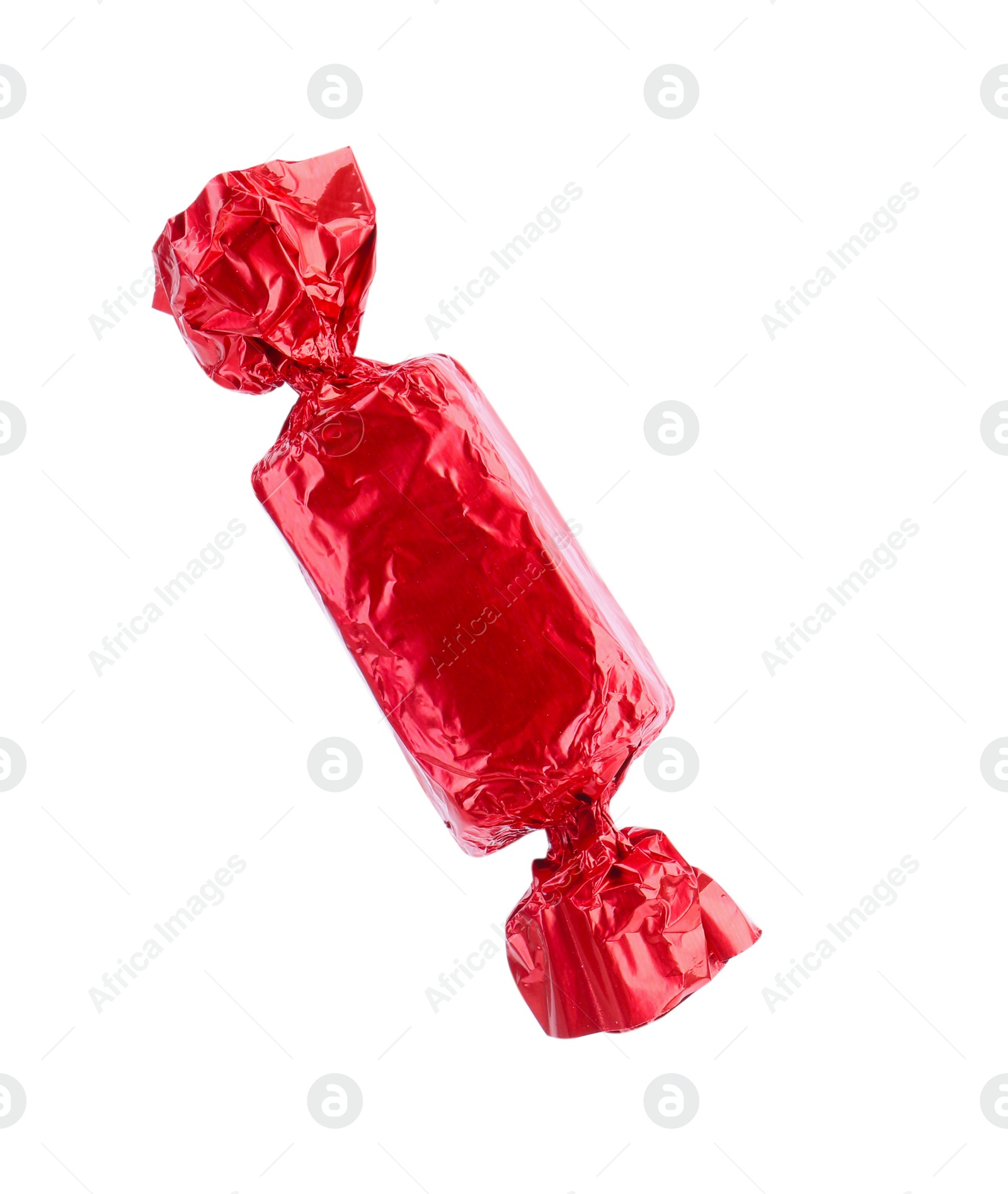 Photo of Tasty candy in red wrapper isolated on white