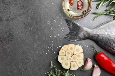 Fresh dorado fish and ingredients on grey table, flat lay. Space for text