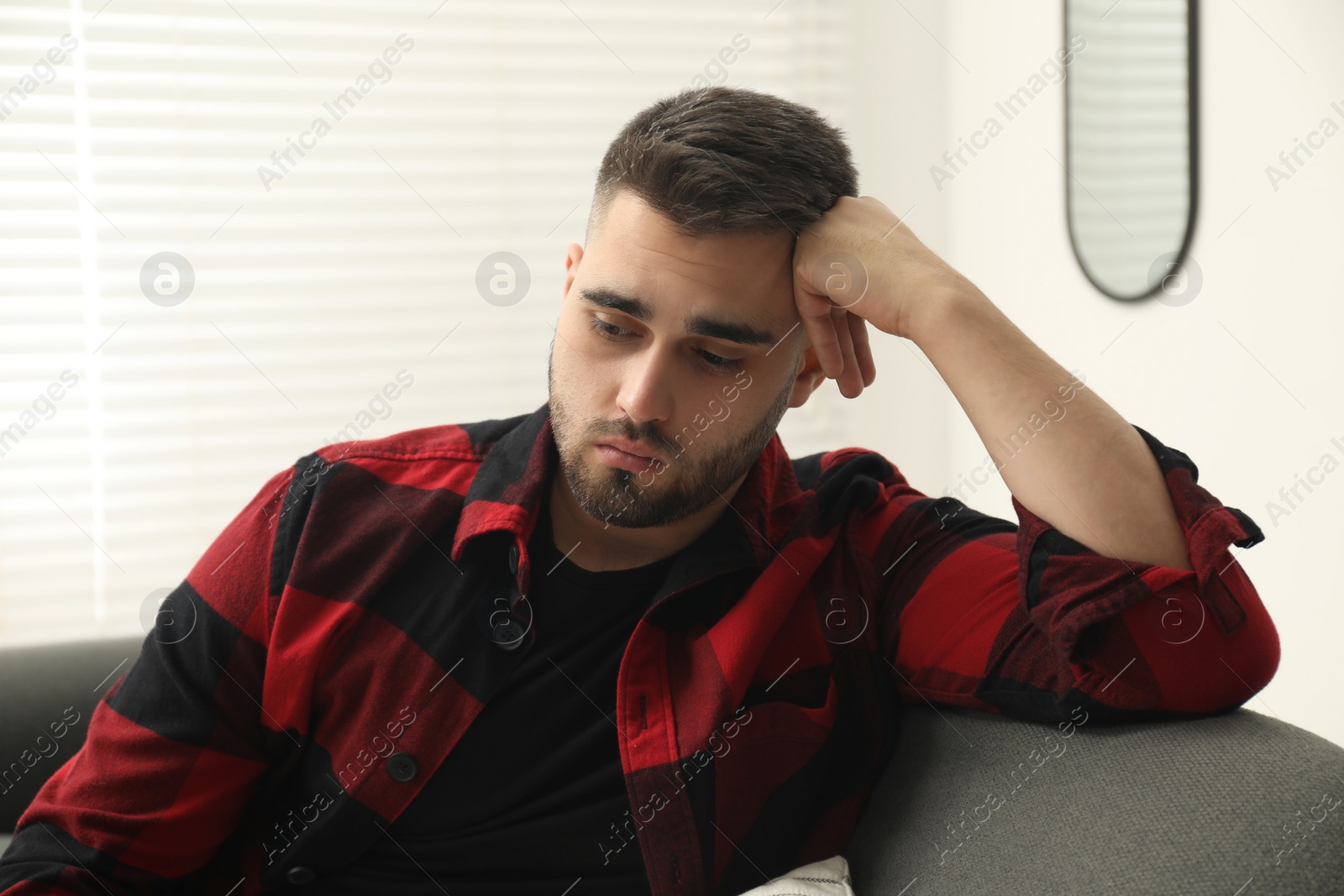 Photo of Portrait of sad lonely man at home