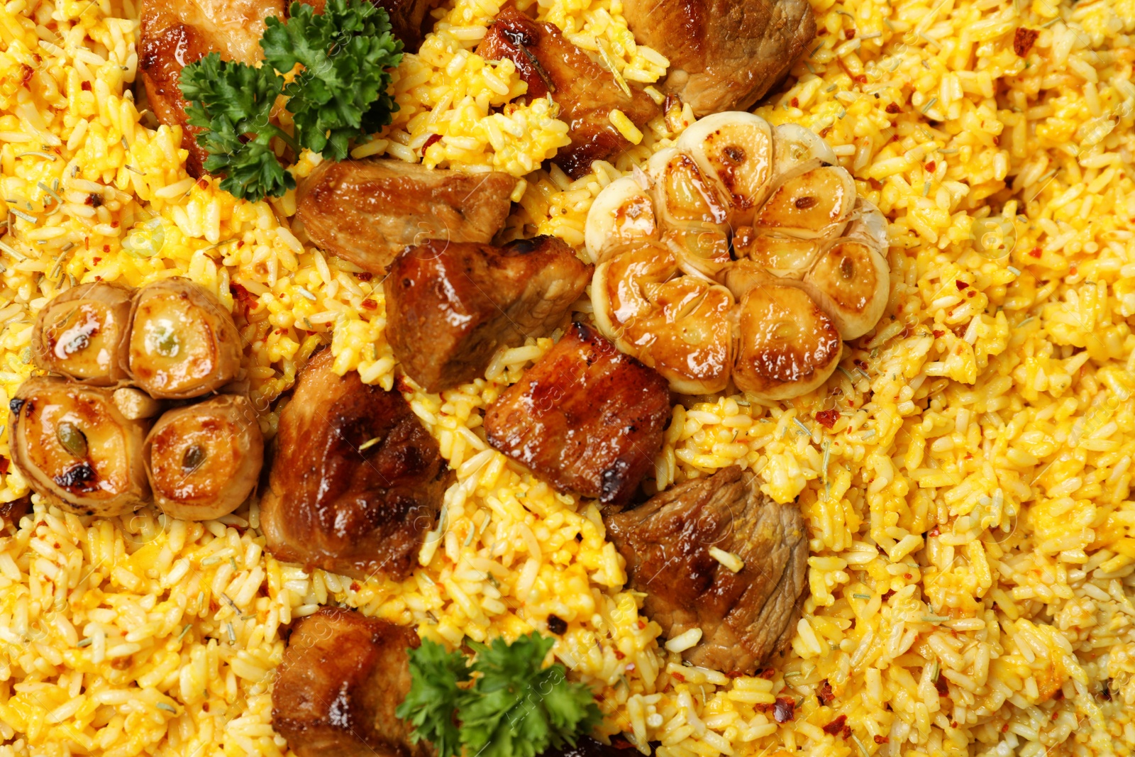 Photo of Delicious rice pilaf with meat as background, top view