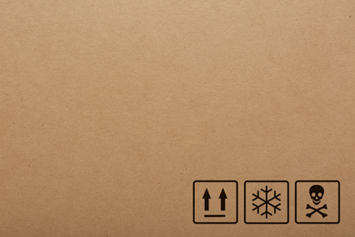 Cardboard box with packaging symbols as background, closeup