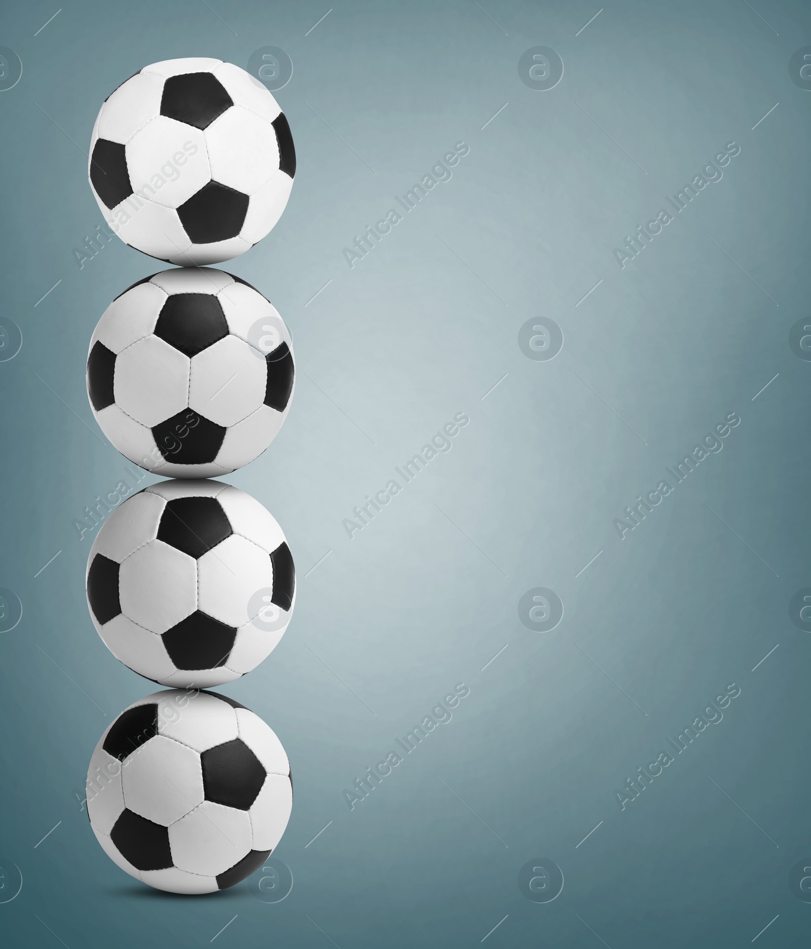 Image of Stack of soccer balls on dusty light blue background. Space for text