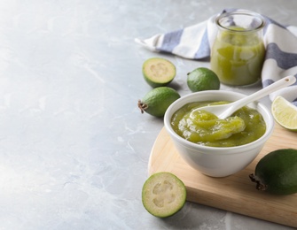 Photo of Feijoa jam on light grey marble table, space for text