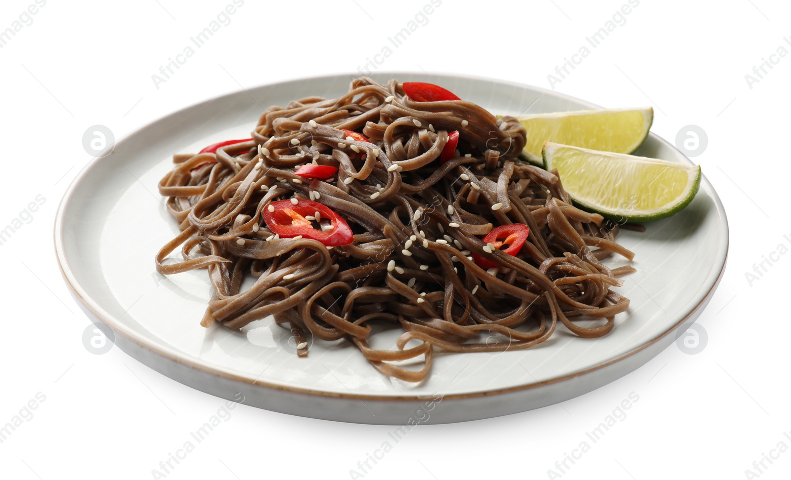 Photo of Tasty buckwheat noodles (soba) with chili pepper, sesame and lime isolated on white