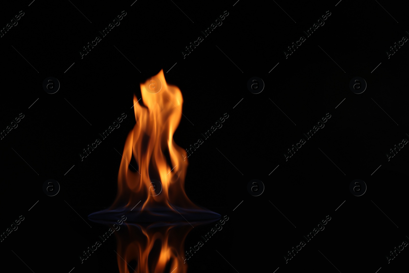 Photo of Beautiful view of flaming vodka on black background