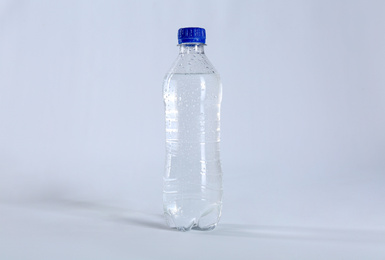 Photo of Plastic bottle of pure water on light background