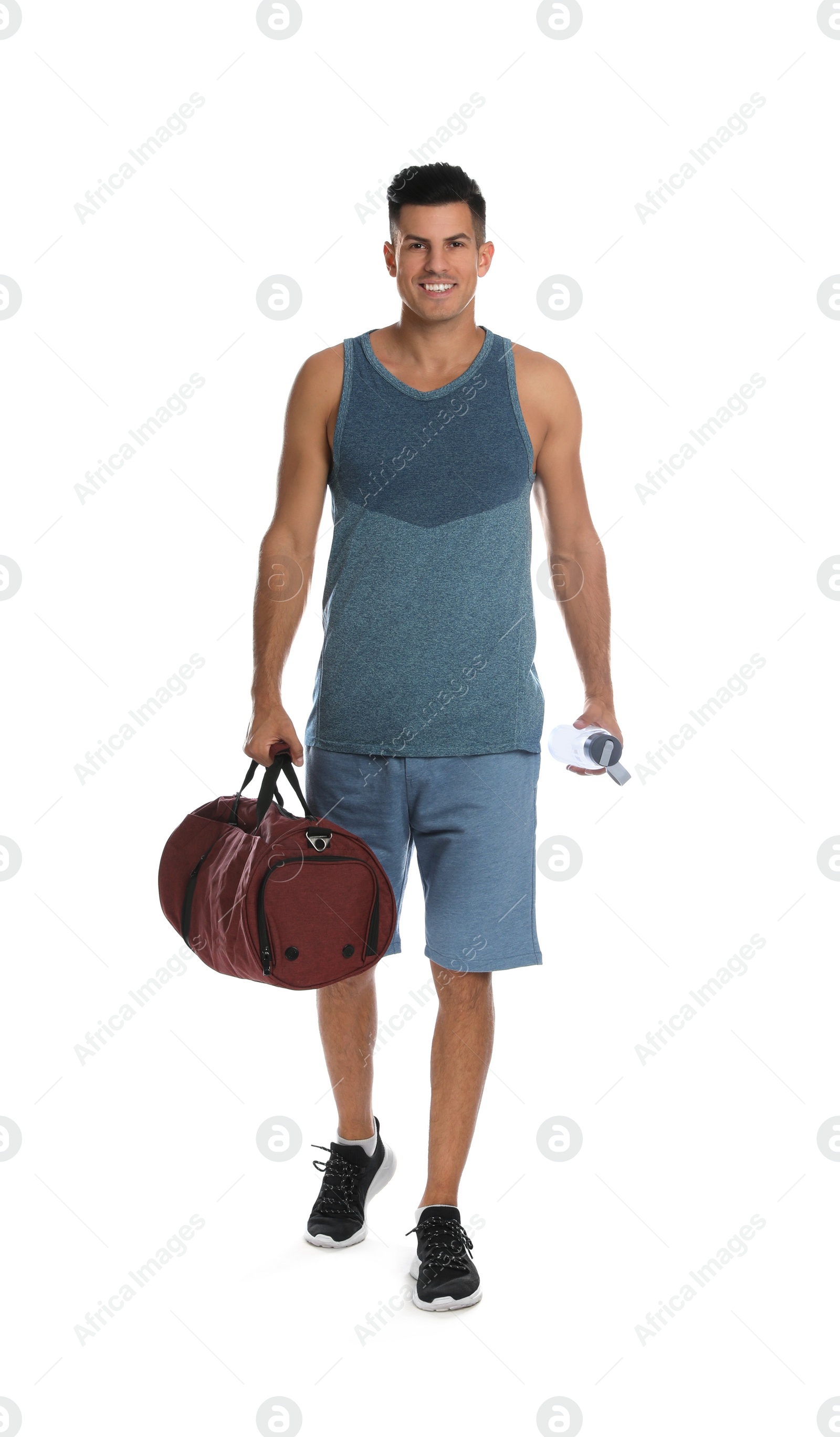 Photo of Handsome man with sports bag and bottle of water on white background