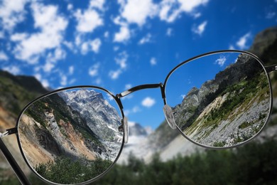 Vision correction. Mountain landscape becoming clearer when looking through glasses