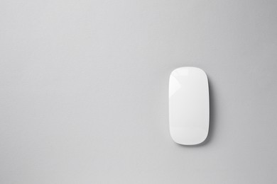 Photo of One wireless mouse on grey background, top view. Space for text