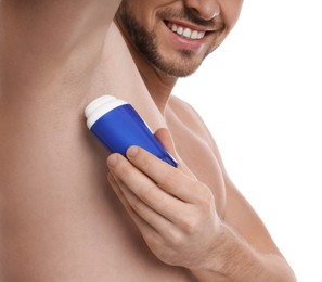 Photo of Man applying deodorant isolated on white, closeup