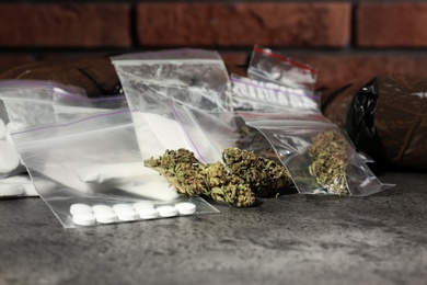Photo of Hemp and other drugs in packages on grey  table