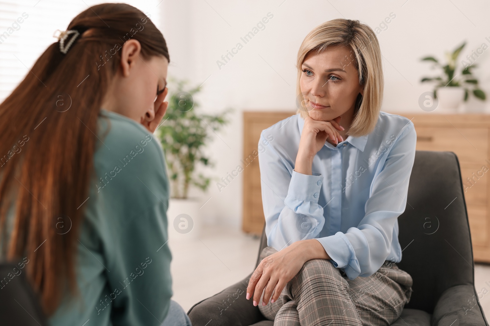 Photo of Professional psychotherapist working with patient in office