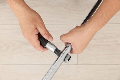 Worker installing new metal pipes indoors, top view