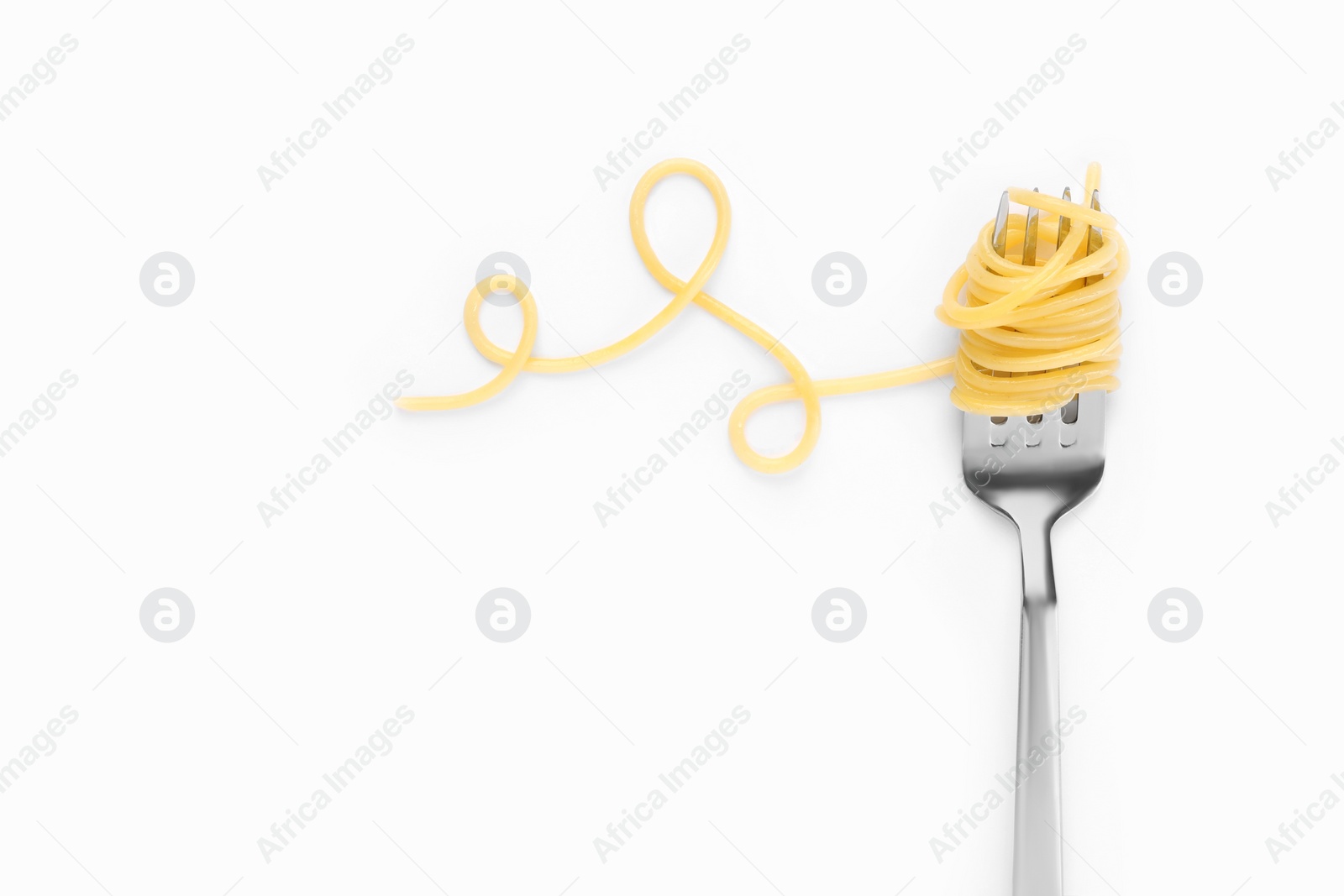 Photo of Fork with tasty pasta on white background, top view. Space for text