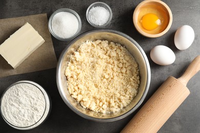 Making shortcrust pastry. Different ingredients for dough and rolling pin on grey table, flat lay