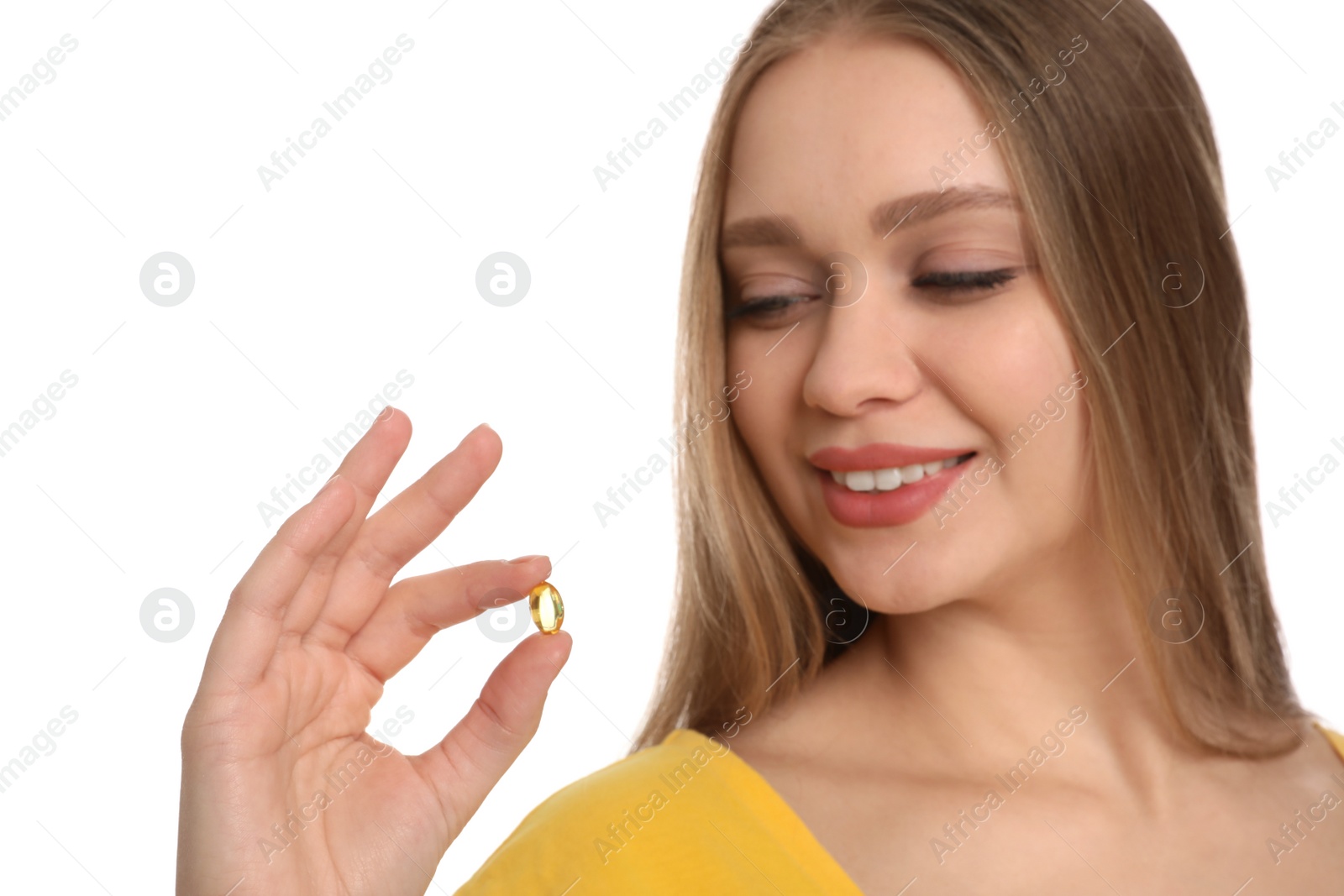 Photo of Young woman with vitamin capsule on white background