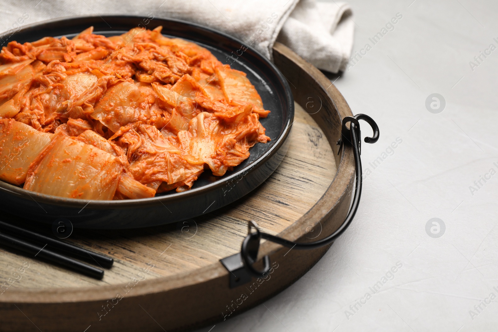 Photo of Delicious kimchi with Chinese cabbage on white table, closeup view